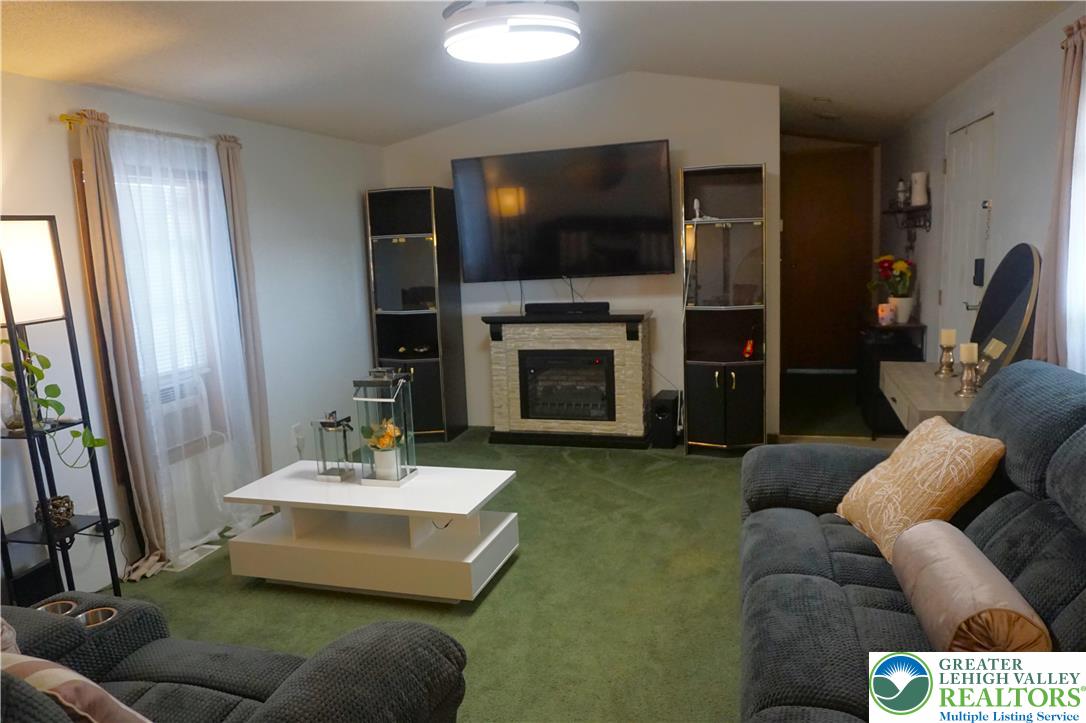3113 Newburg Road Nazareth, PA 18064 - Photo 5 of 18 a living room with fireplace furniture and a flat screen tv