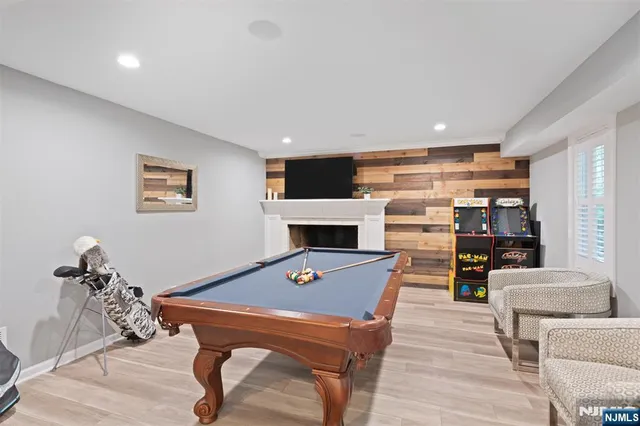 a living room with furniture a flat screen tv and a table