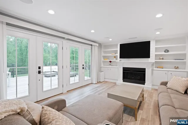 a living room with furniture a fireplace and a flat screen tv
