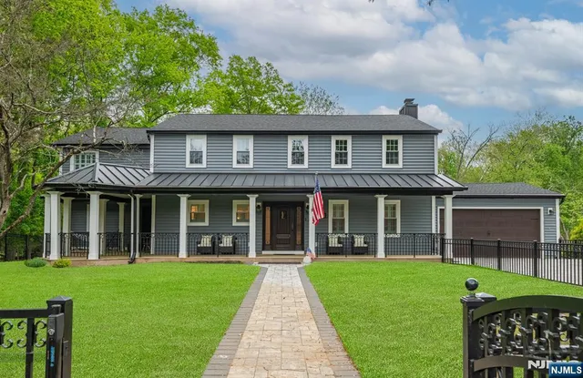 a view of brick house with a yard and plants