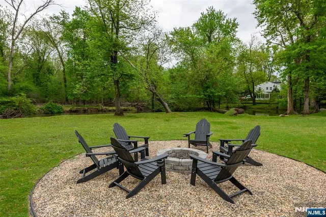 a view of a lake with furniture and garden