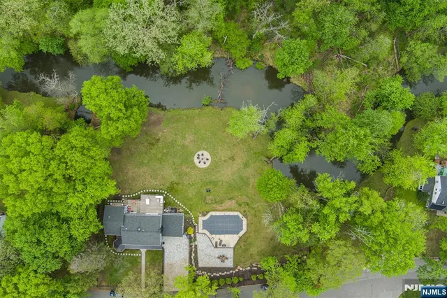 an aerial view of a house with yard swimming pool and outdoor seating