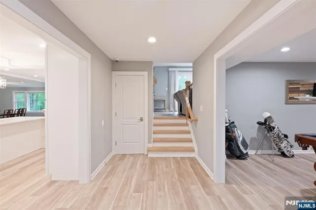 a view of a hallway with wooden floor and stairs