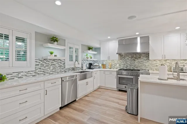 a kitchen with granite countertop white cabinets and white appliances