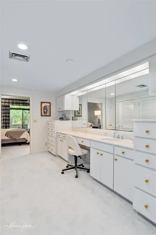 a view of a double vanity sink and a window