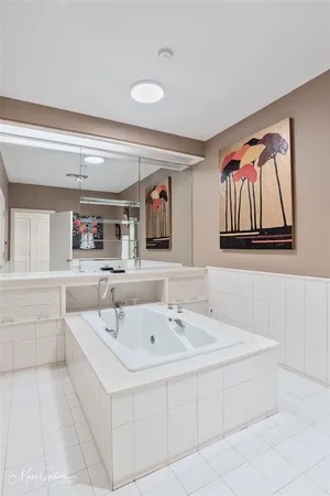 a spacious bathroom with a bathtub and a mirror