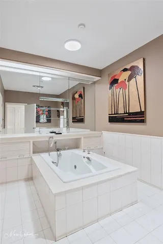 a spacious bathroom with a bathtub and a mirror