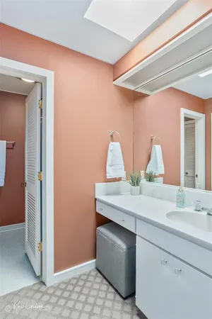 a room with a sink and a mirror