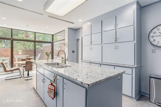 a open kitchen with stainless steel appliances granite countertop a sink and cabinets