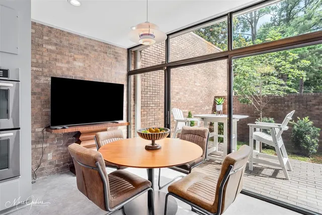 a dining room with furniture and wooden floor