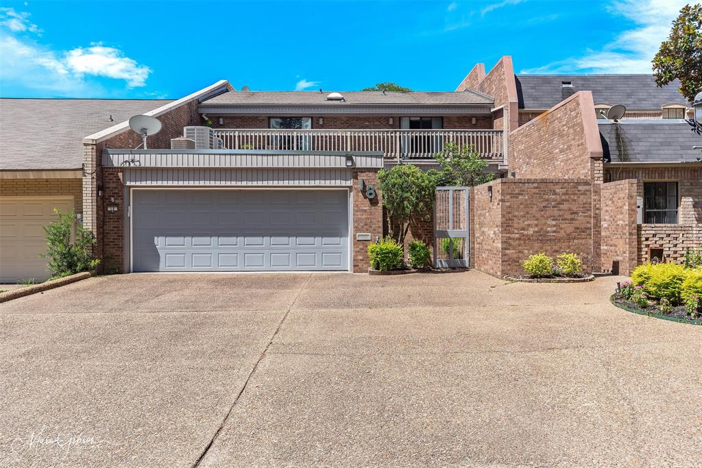 300 Pierremont Road, Unit 18 Shreveport, LA 71106 - Photo 36 of 40 a front view of a house with a yard and garage