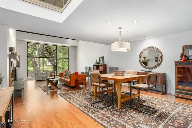 a living room with furniture a window and a clock