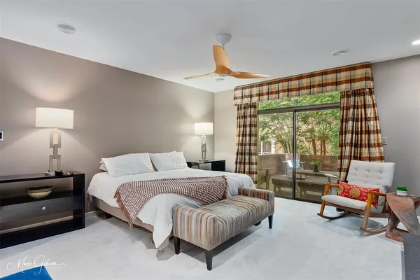 a bedroom with furniture and a large window