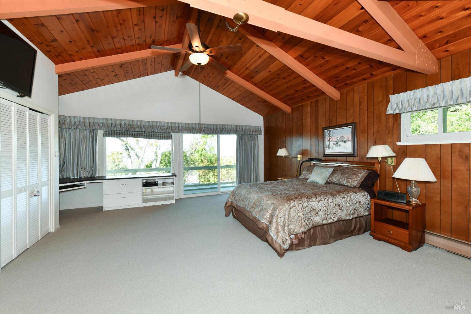 22 Monez Boulevard Napa, CA 94559 - Photo 14 of 30 a spacious bedroom with a bed and a chandelier