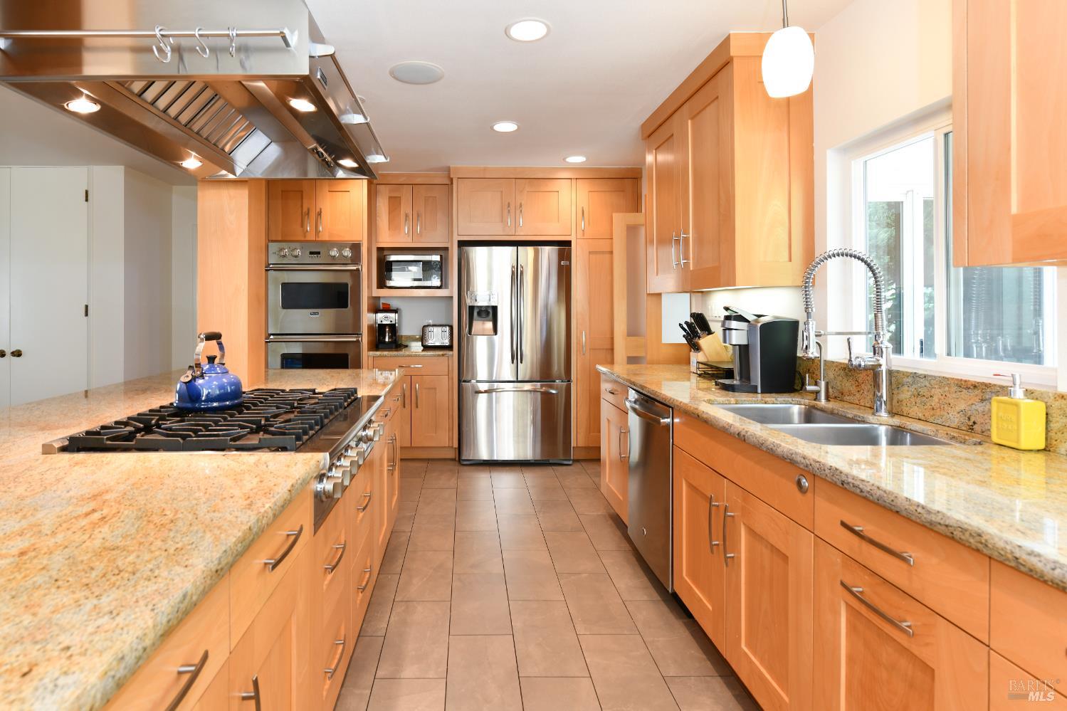 22 Monez Boulevard Napa, CA 94559 - Photo 10 of 30 a kitchen with stainless steel appliances granite countertop a sink and a refrigerator