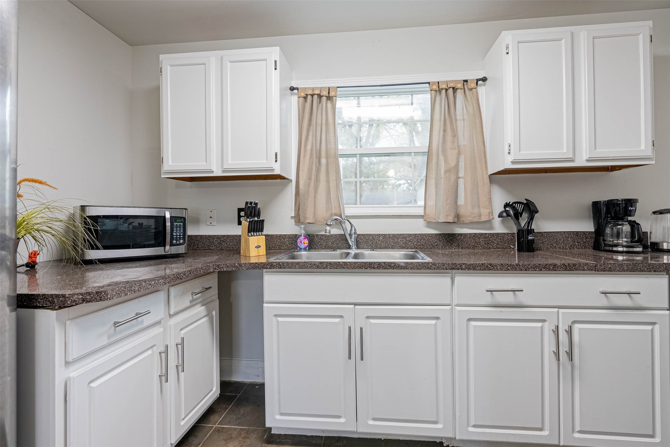 3910 Luca Street Houston, TX 77021 - Photo 14 of 29 a kitchen with white cabinets and sink
