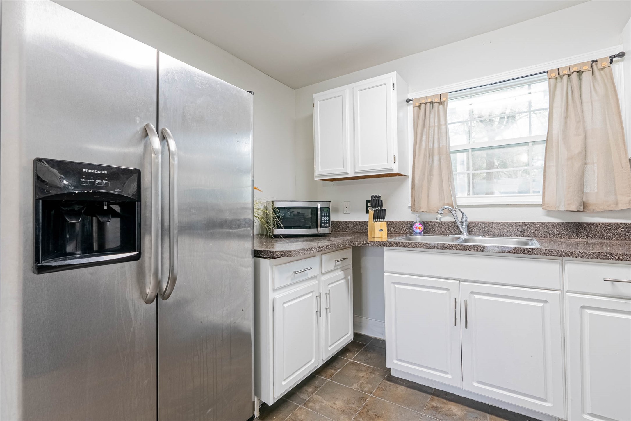 3910 Luca Street Houston, TX 77021 - Photo 15 of 29 a kitchen with a refrigerator and white cabinets