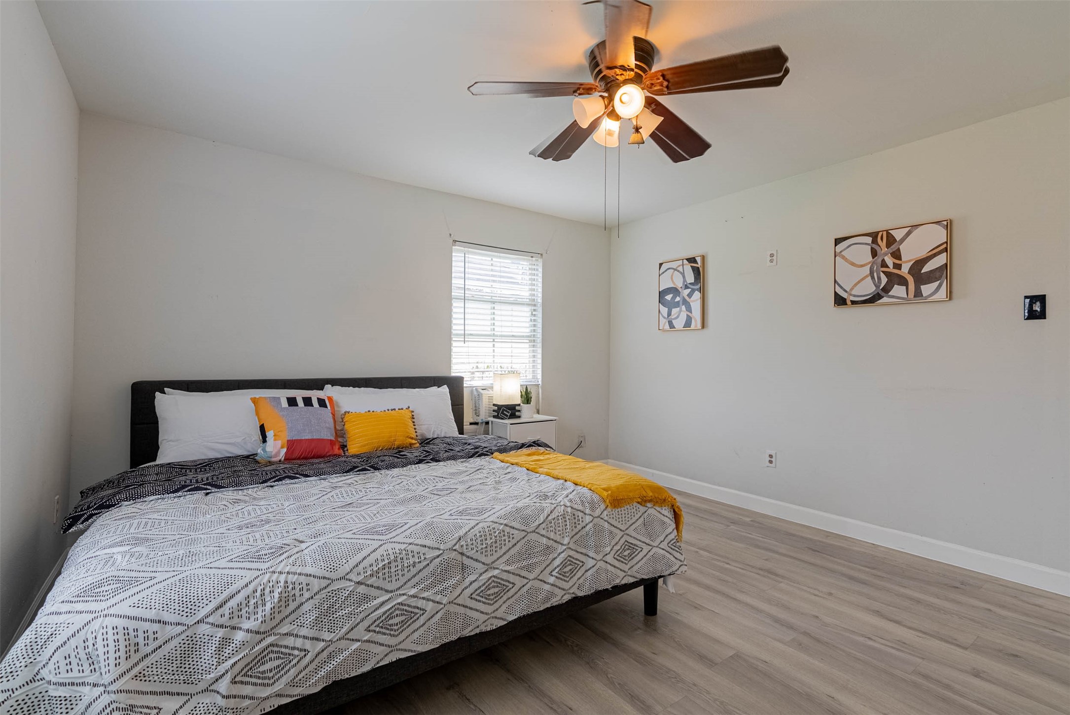 3910 Luca Street Houston, TX 77021 - Photo 19 of 29 a bedroom with a large bed and a chandelier