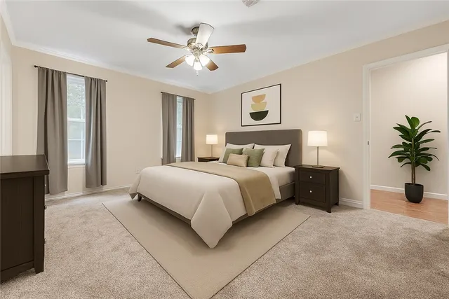 a bedroom with a large bed and a chandelier