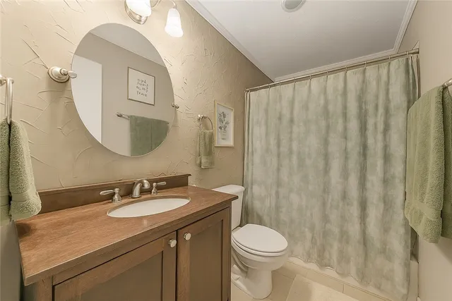 a bathroom with a double vanity sink toilet and a mirror