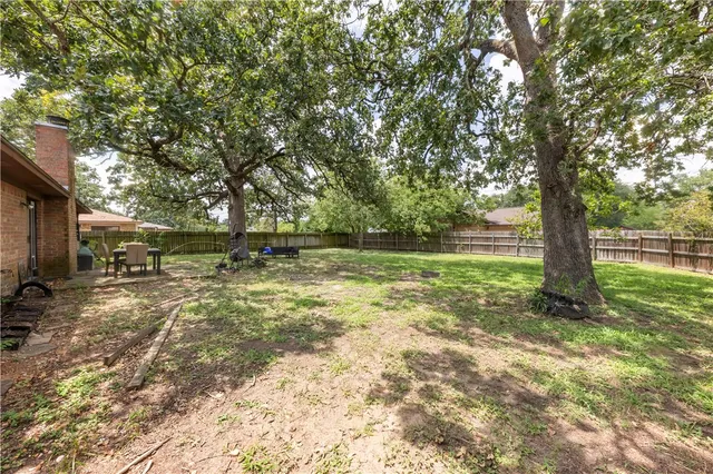 a backyard of a house with lots of green space