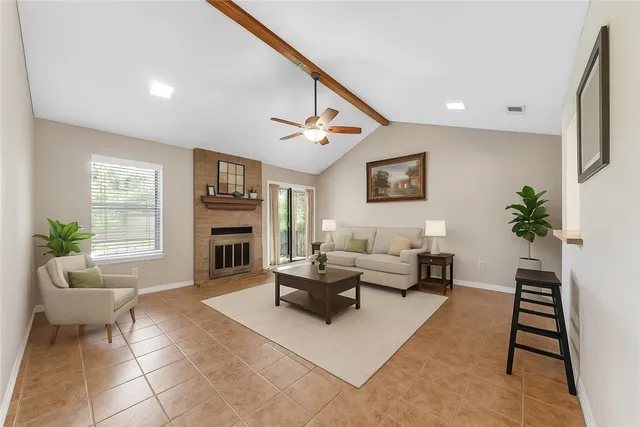 a living room with furniture a window and a fireplace