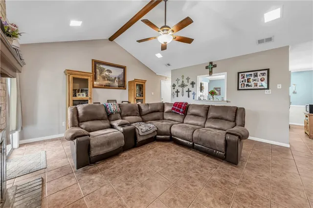 a living room with furniture and a ceiling fan