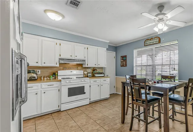 a kitchen that has a cabinets counter space and stainless steel appliances