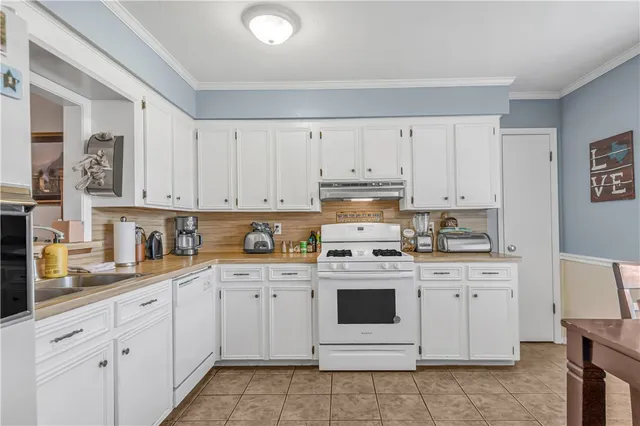a kitchen with cabinets stainless steel appliances and sink