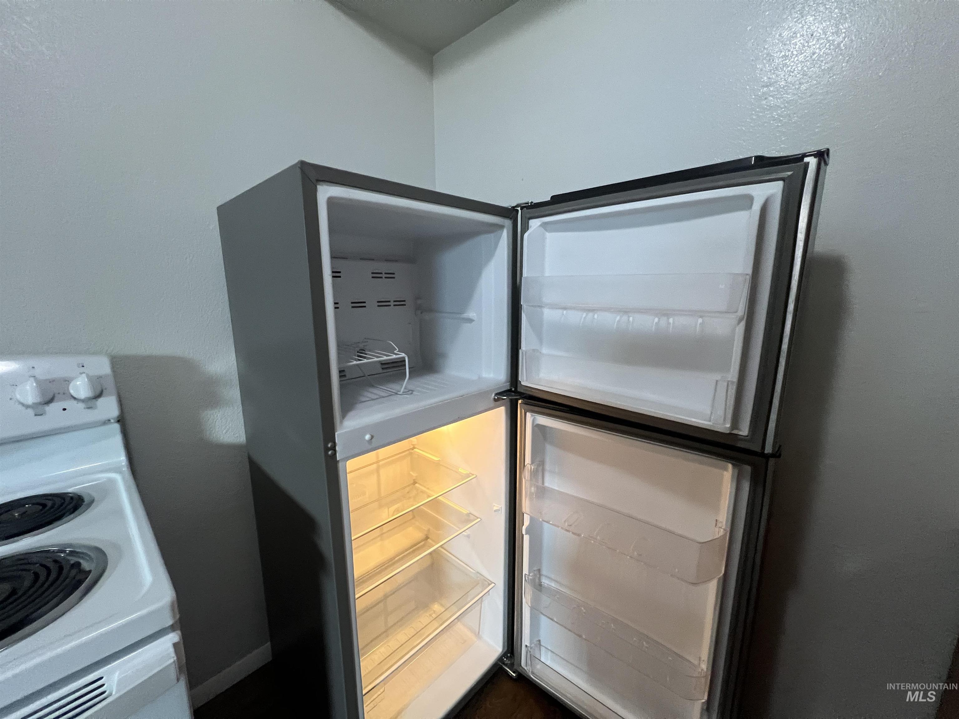 151 Northwest 8th Street Ontario, OR 97914 - Photo 11 of 30 Kitchen view of white range with electric cooktop and freestanding refrigerator