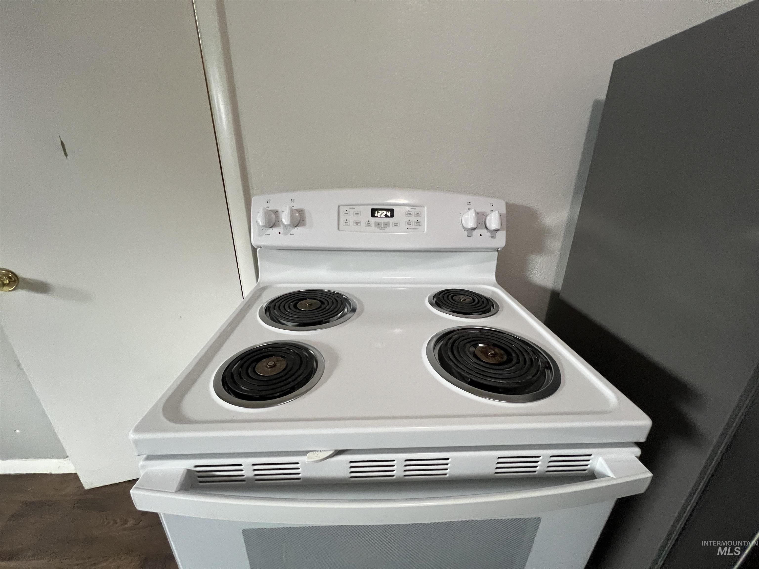 151 Northwest 8th Street Ontario, OR 97914 - Photo 8 of 30 Kitchen view of white electric range and dark wood-type flooring