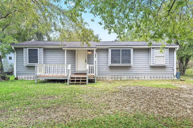 a backyard of a house with table and chairs