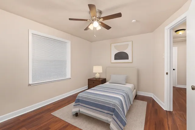 a bedroom with bed and a window