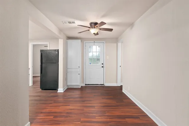 wooden floor in an empty room with a window