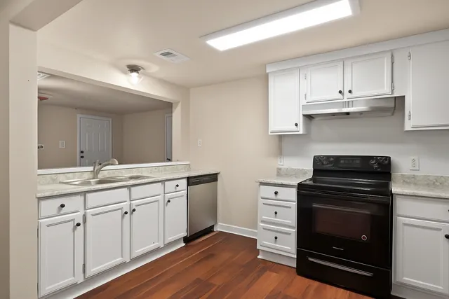 a kitchen with a stove oven and sink