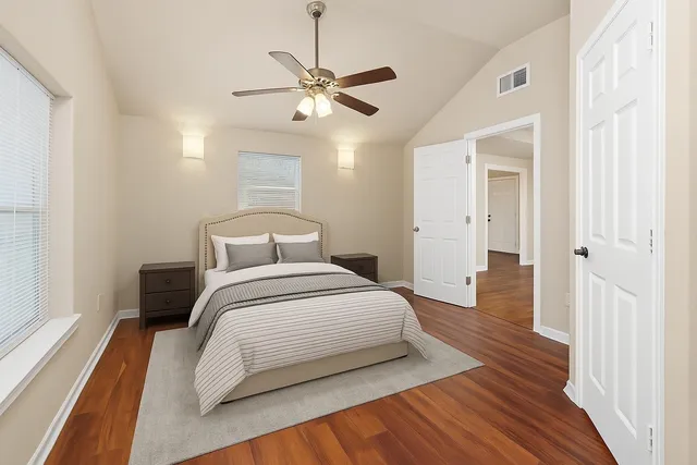 a bedroom with a bed and wooden floor