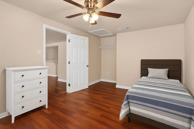 a bedroom with a bed and a dresser