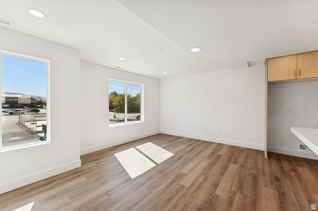 254 North Main Street Bountiful, UT 84010 - Photo 10 of 45 Unfurnished room featuring light wood finished floors, recessed lighting, and a textured ceiling