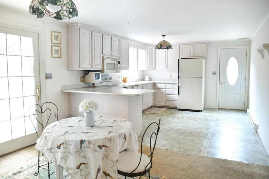 a kitchen with a refrigerator sink and cabinets