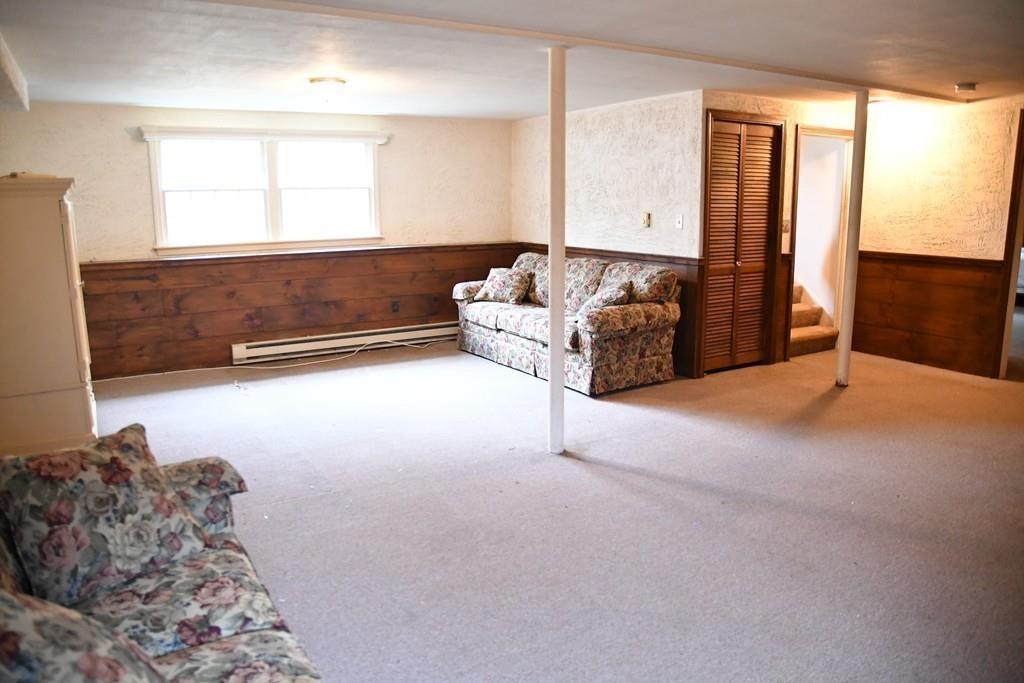 45 Powder Mill Road Sudbury, MA 01776 - Photo 16 of 20 a spacious bedroom with a bed and a couch