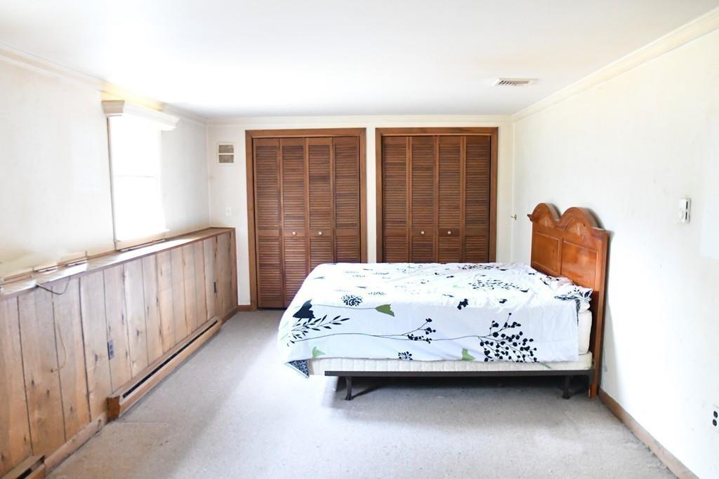 45 Powder Mill Road Sudbury, MA 01776 - Photo 17 of 20 a bedroom with a bed and a window