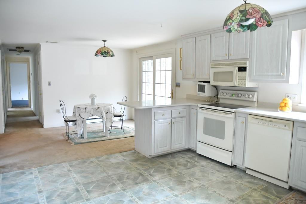 45 Powder Mill Road Sudbury, MA 01776 - Photo 6 of 20 a kitchen with cabinets and chairs
