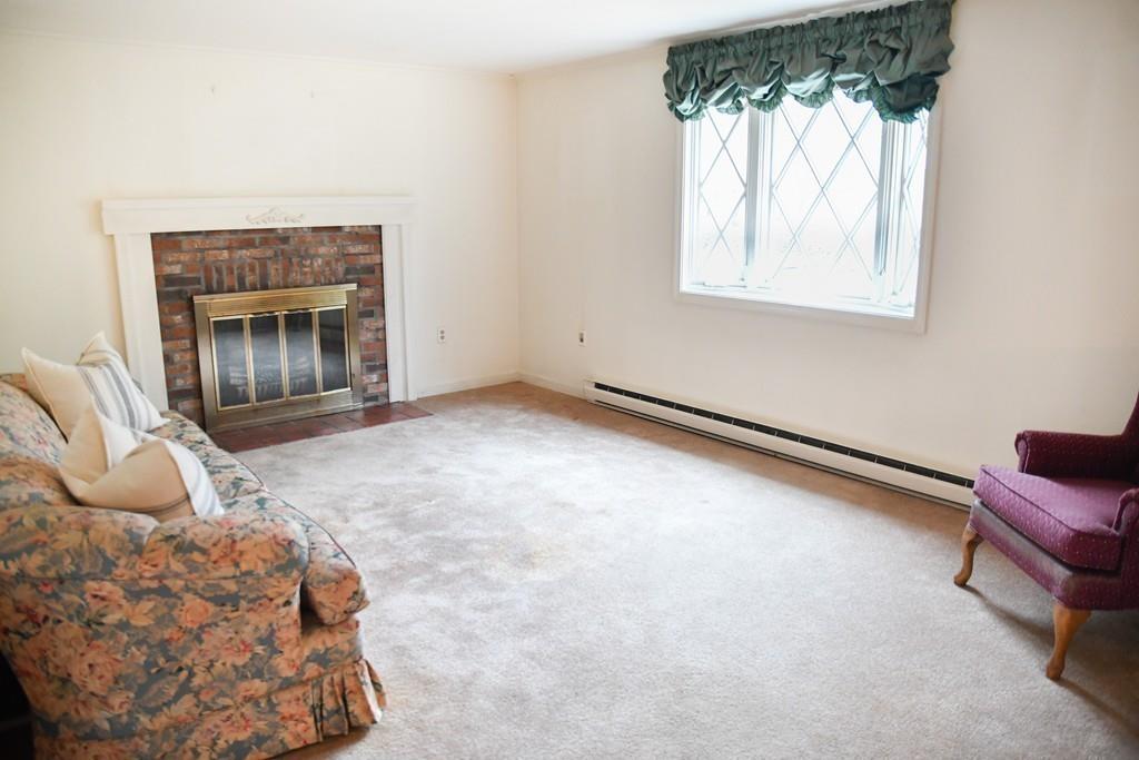 45 Powder Mill Road Sudbury, MA 01776 - Photo 7 of 20 a bedroom with a bed and a chair