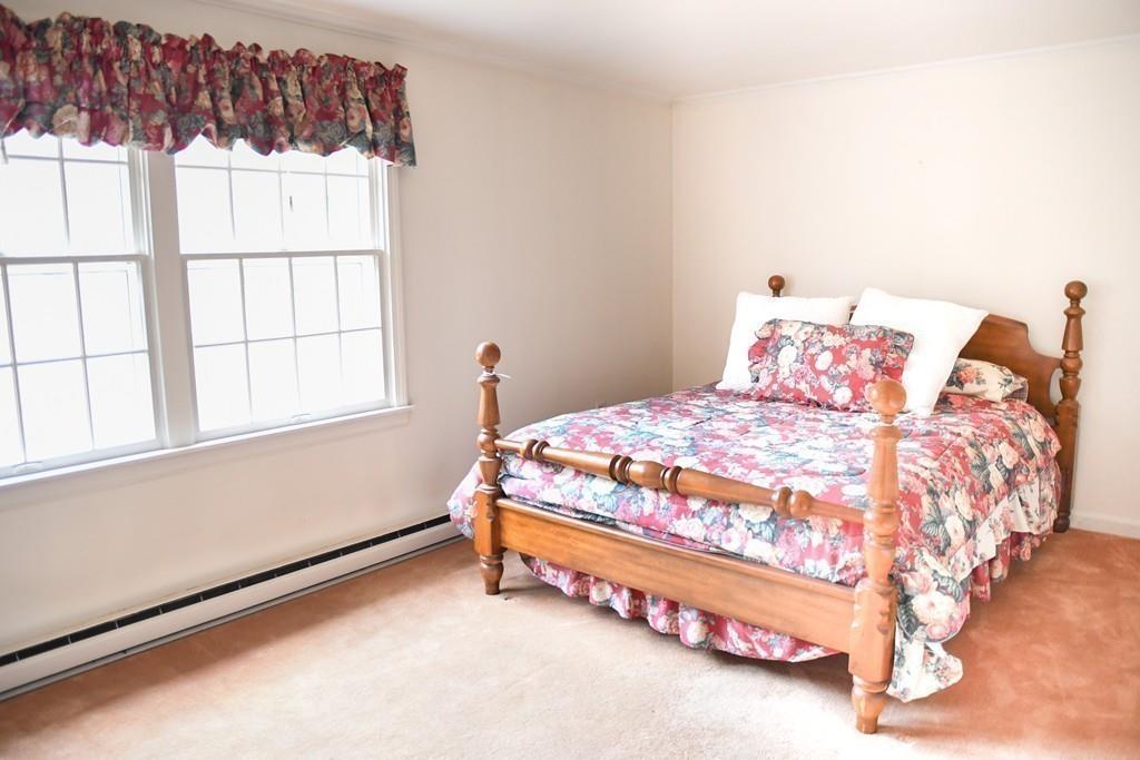 45 Powder Mill Road Sudbury, MA 01776 - Photo 10 of 20 a bed sitting in a bedroom next to a window