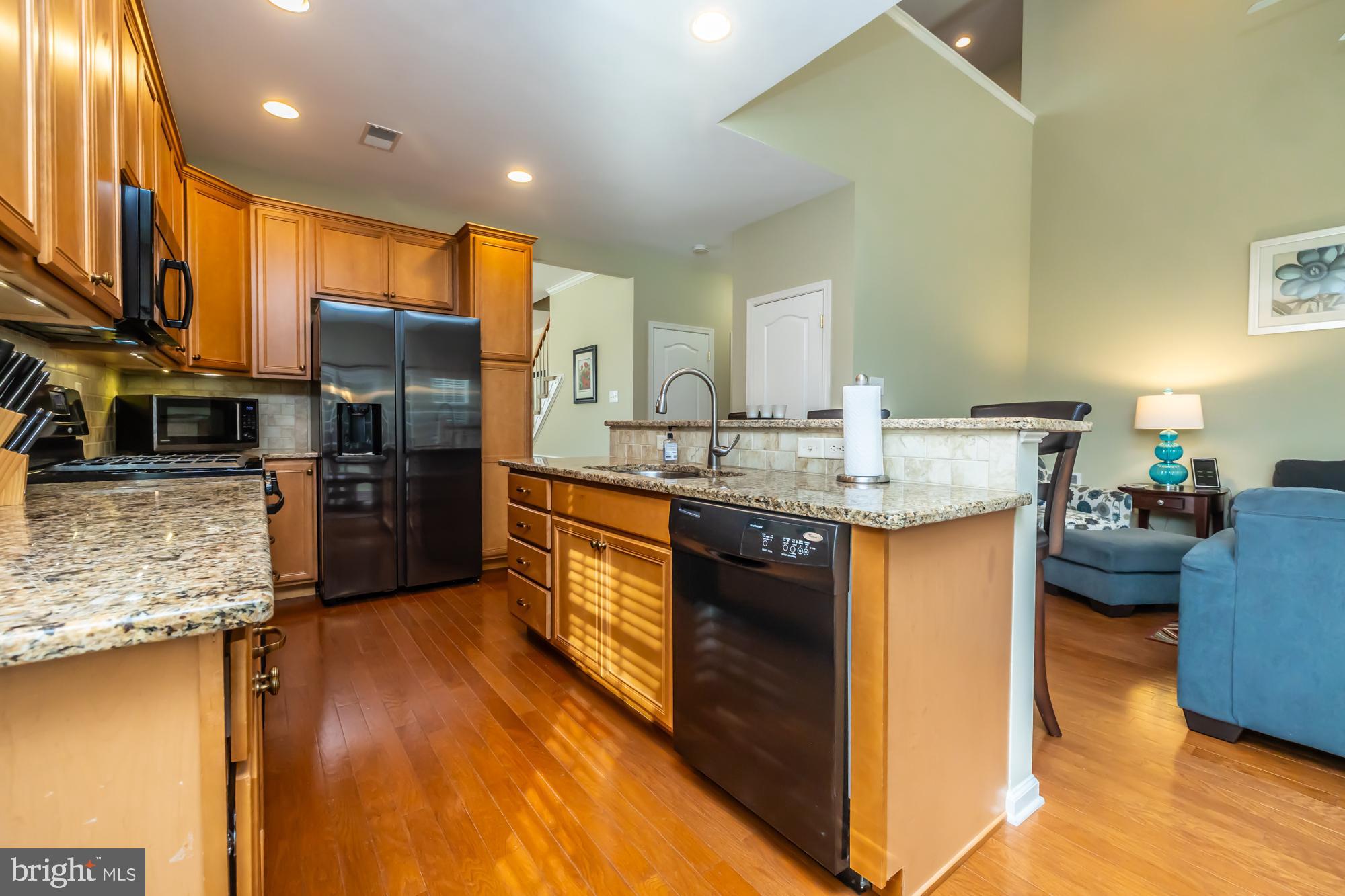 141 Stoyer Road Coatesville, PA 19320 - Photo 12 of 40 a kitchen with stainless steel appliances granite countertop a sink a stove and a refrigerator