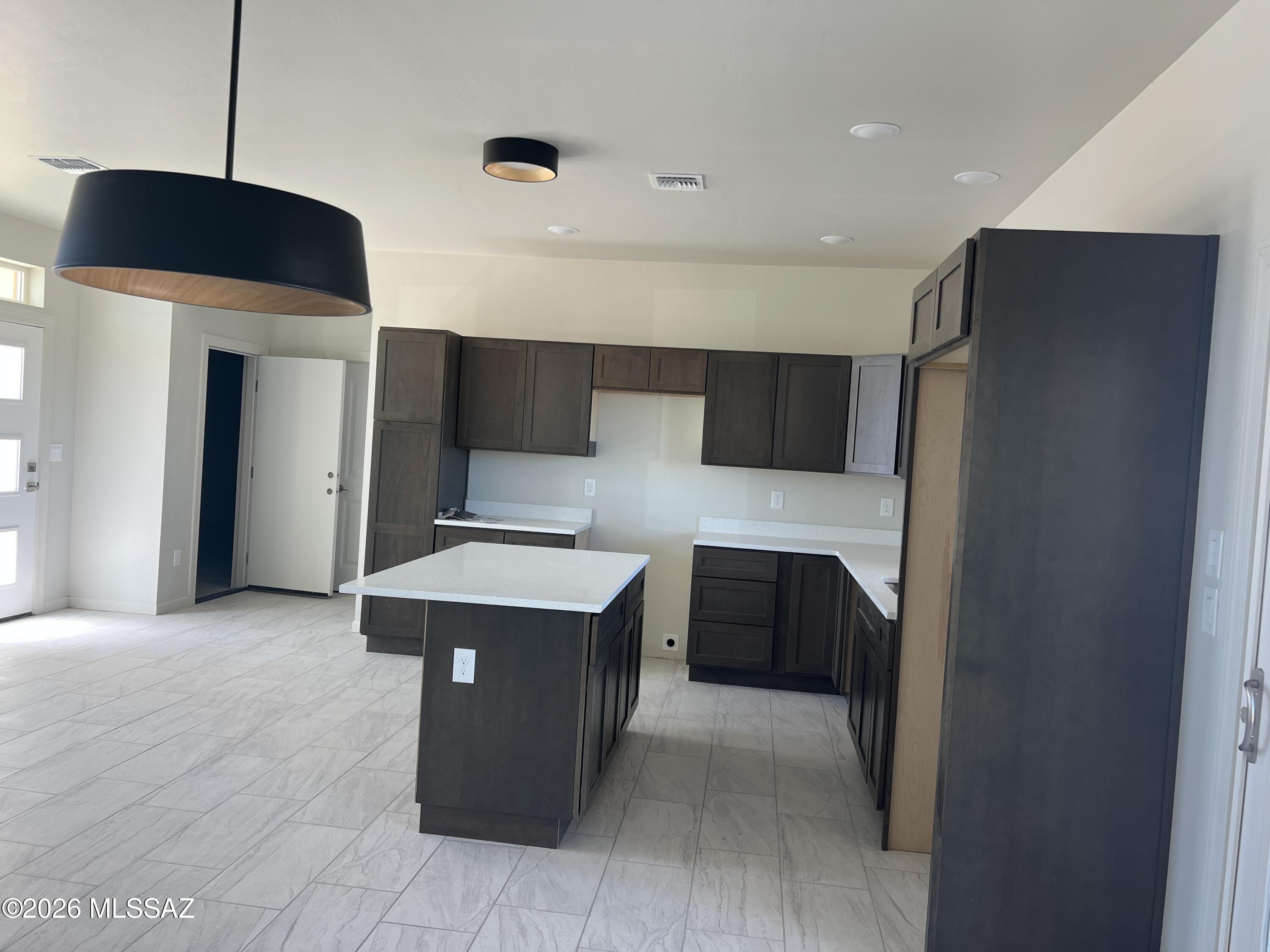 1501 Circulo Sombrero Rio Rico, AZ 85648 - Photo 10 of 26 a kitchen with stainless steel appliances a refrigerator and a wooden floor