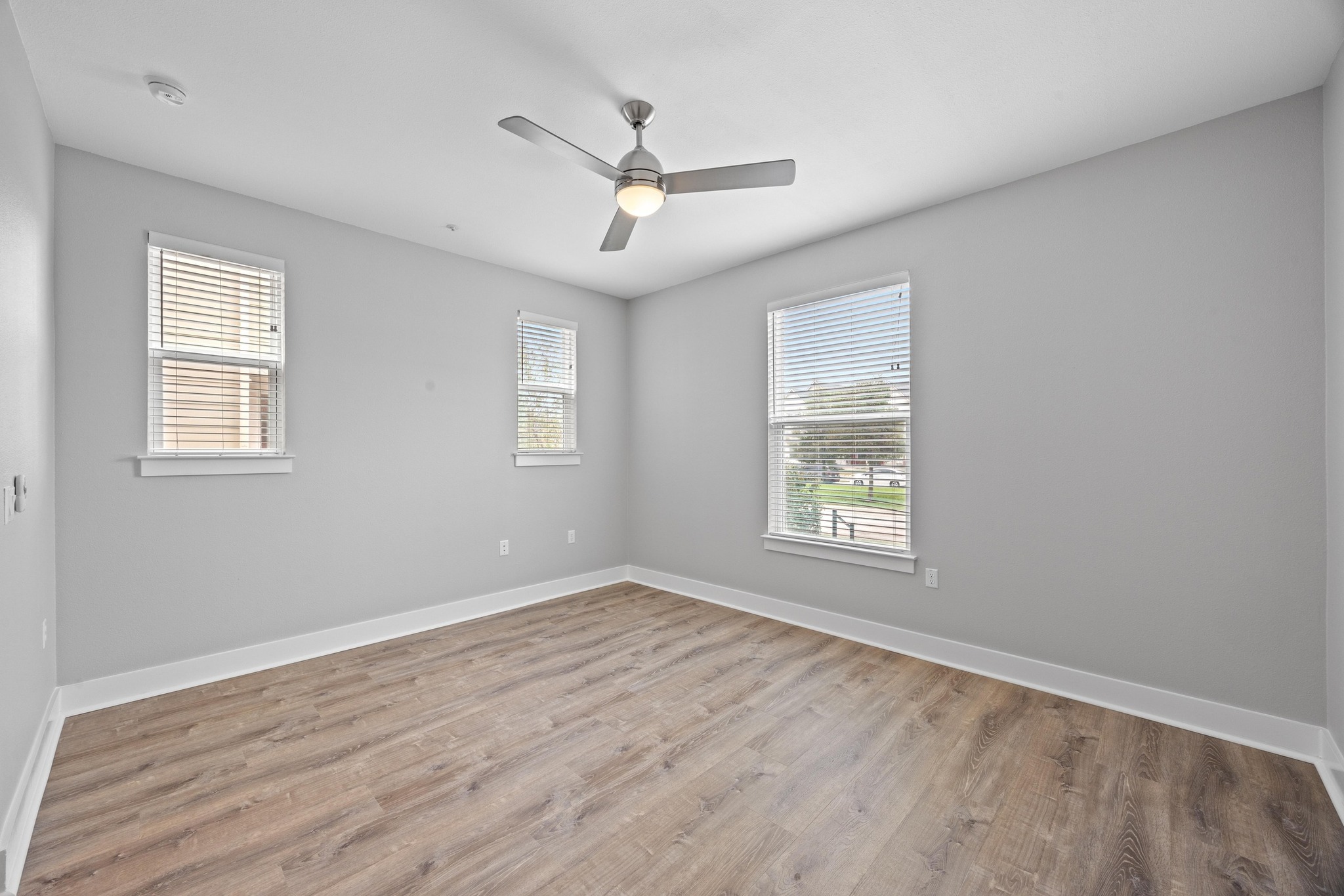 2222 Simond Avenue, Unit E Austin, TX 78723 - Photo 14 of 28 The primary bedroom is on the main floor, with LVP and good natural light.