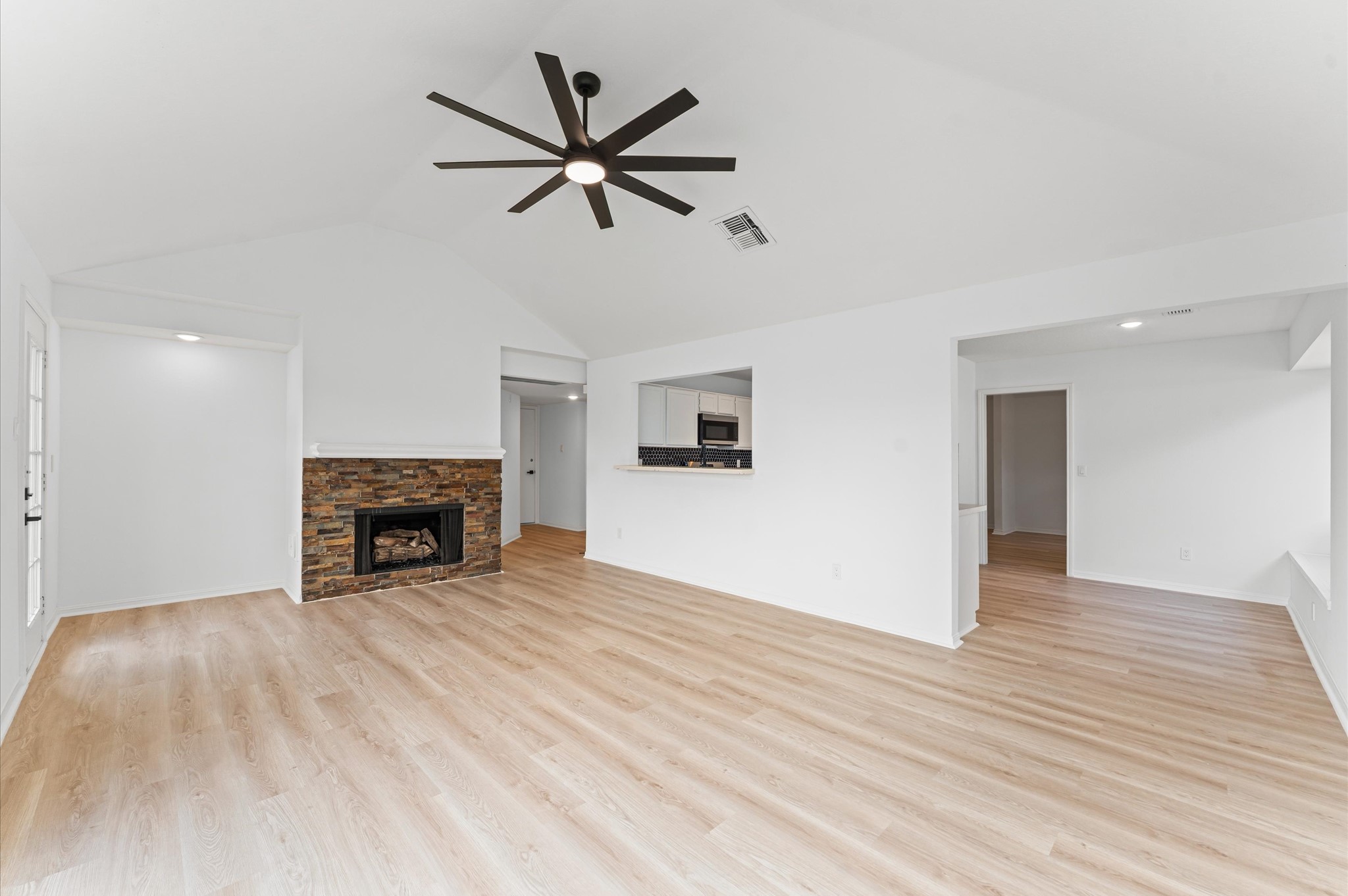 17527 Hamilwood Drive Cypress, TX 77433 - Photo 12 of 32 an empty room with wooden floor fireplace and windows
