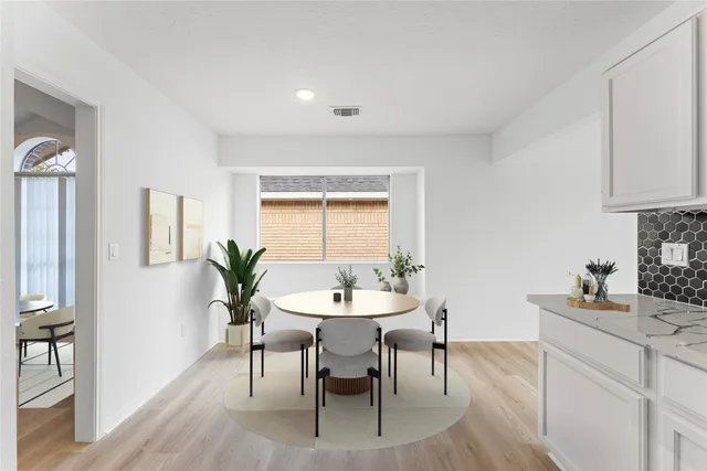 a dining room with furniture and window