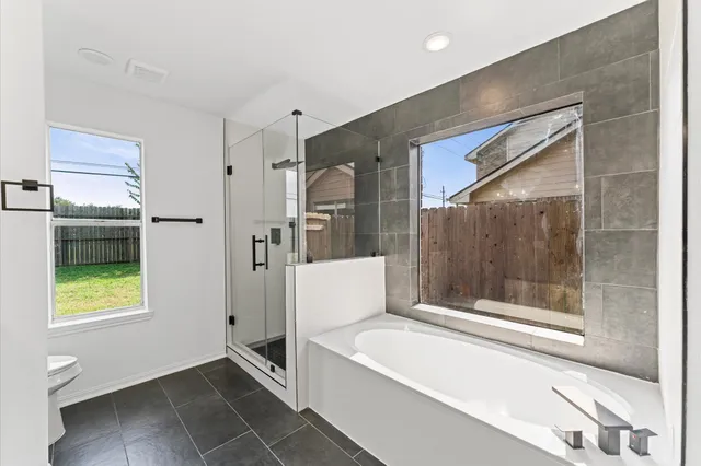 a bathroom with a bathtub and a shower